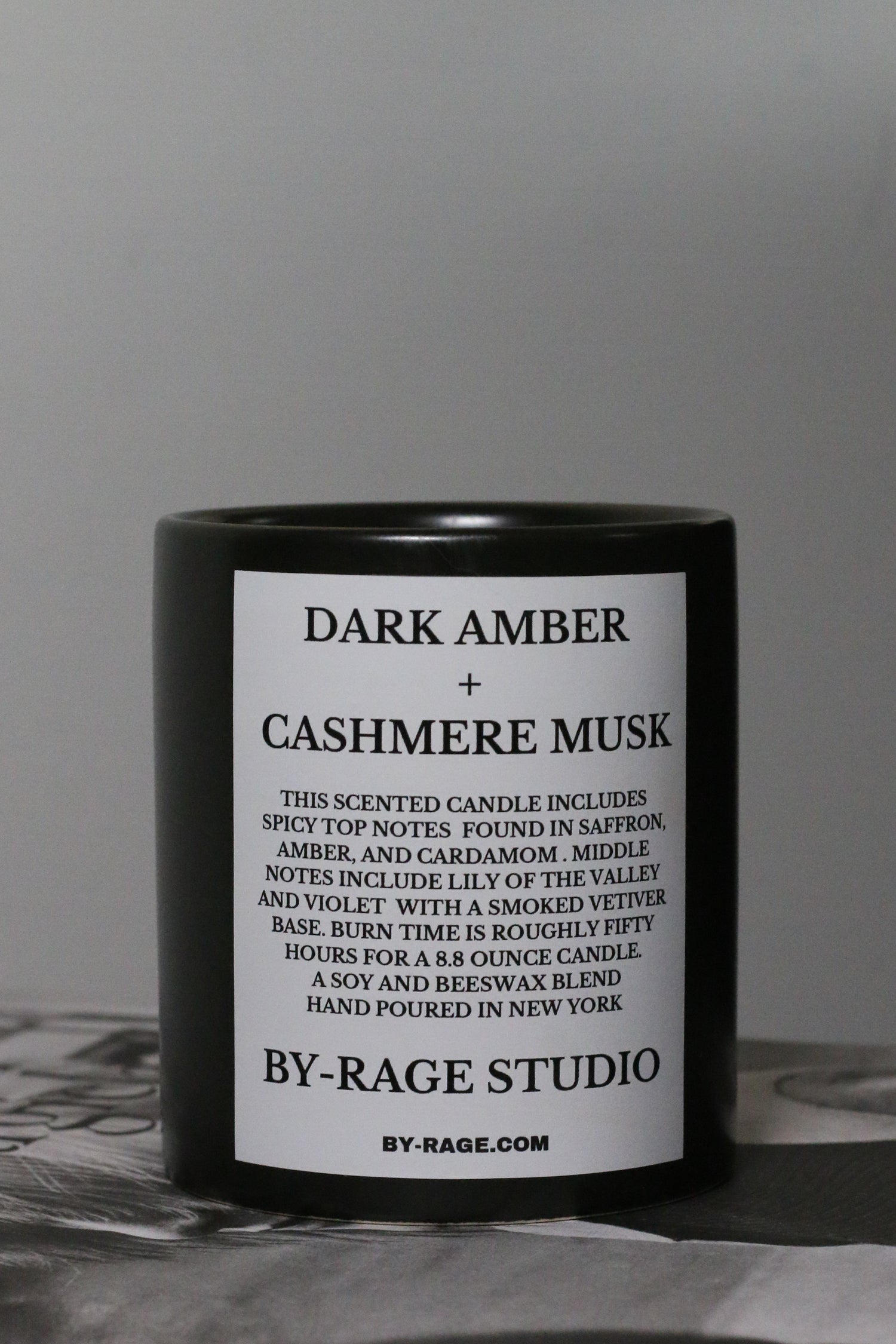 This scented candle includes spicy top notes found in saffron, amber, and cardamom. Middle notes include lily of the valley and violet with a smoked vetiver base. Burn time is roughly fifty hours for an 11.1 ounce candle.  This candle is a soy and beeswax blend with a braided cotton wick and ceramic vessel.